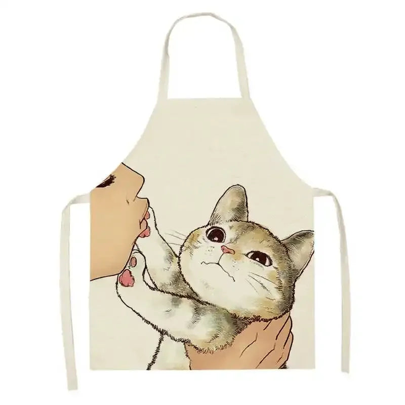 Kawaii apron with a cartoon design of a cat being held by a person's face on a white background
