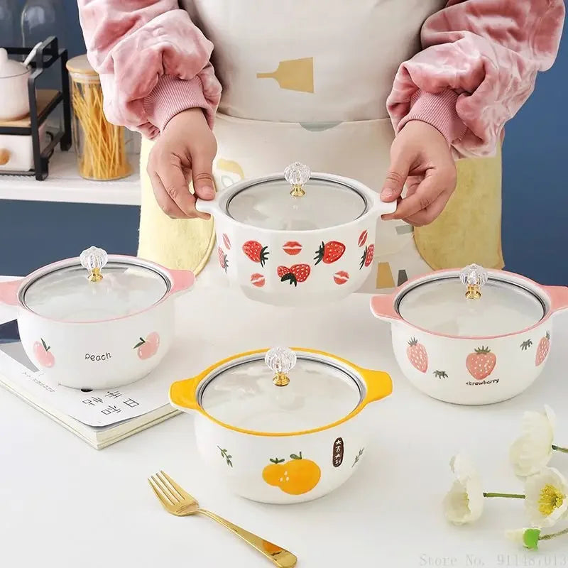 Someone holding a strawberry designed kawaii ramen bowl