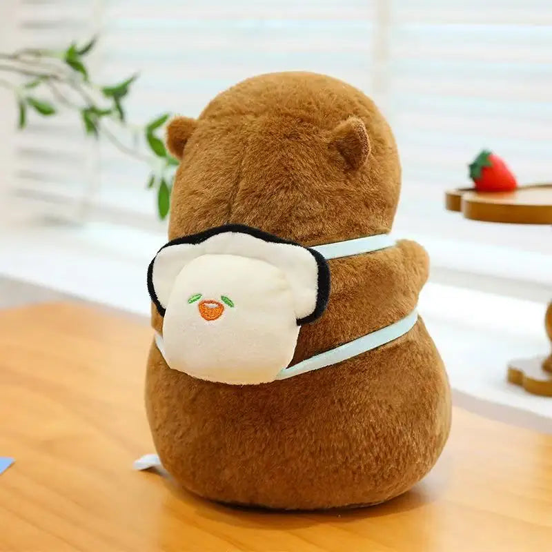 Kawaii plush toy resembling a bear with a face mask on a wooden surface