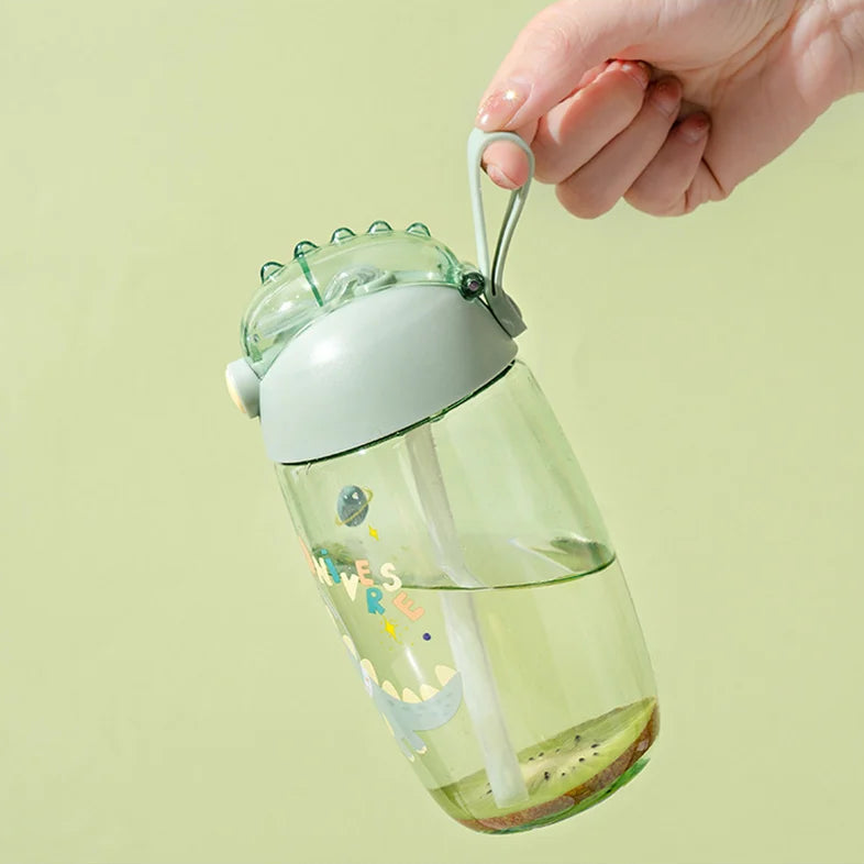 Clear kawaii water bottle with straw and handle on a light green background