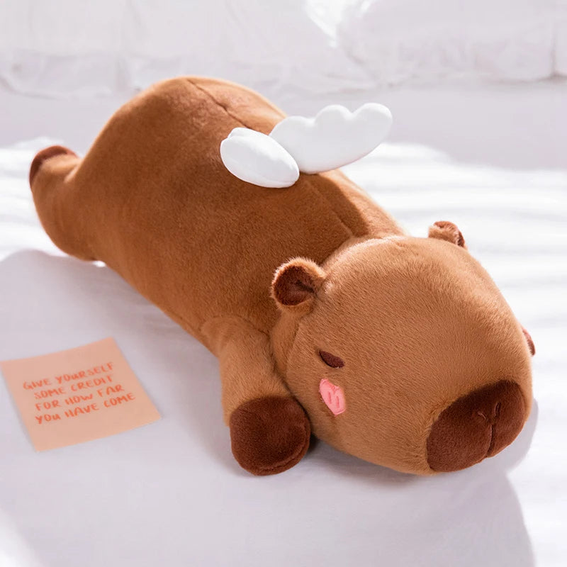 Kawaii plush toy shaped like a moose on a white surface with a small card beside it.