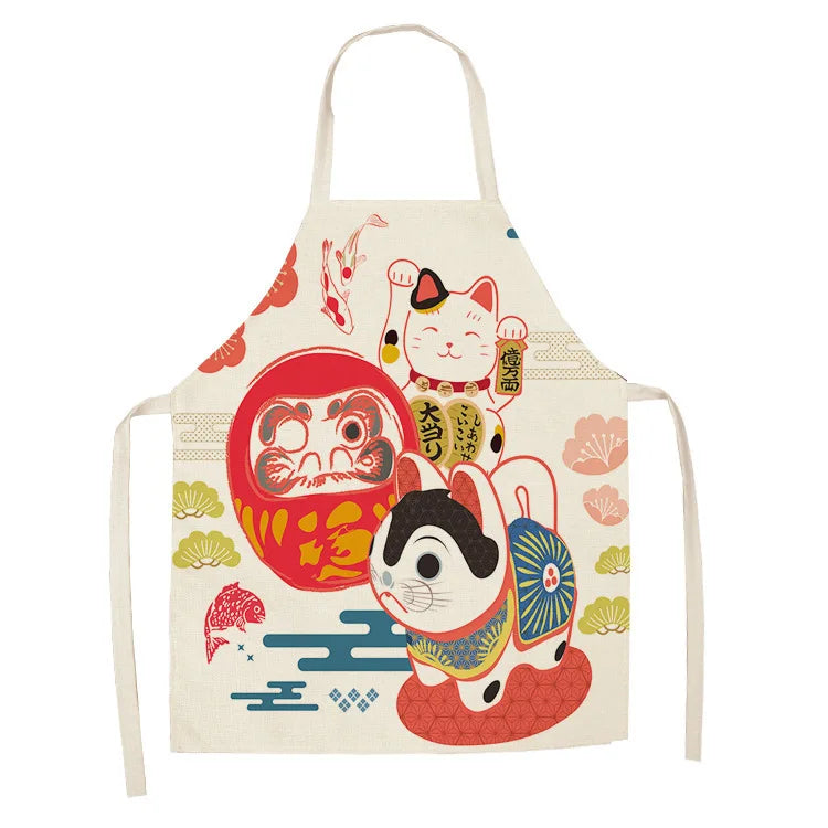 Kawaii apron with cartoon cat and Daruma doll design on a white background
