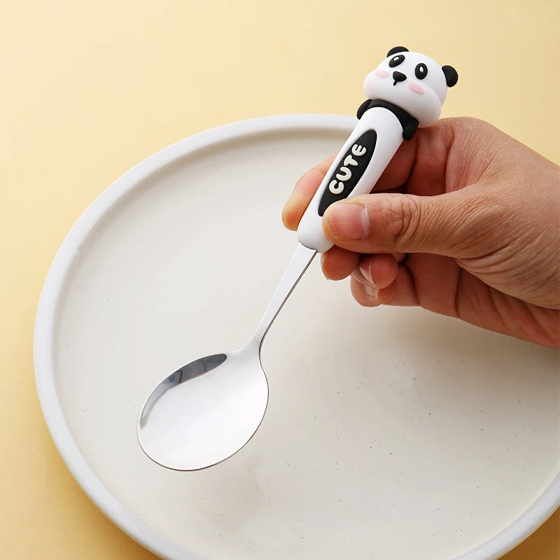 A kawaii spoon with panda handle labeled 'Cute' held over a white plate on a yellow background