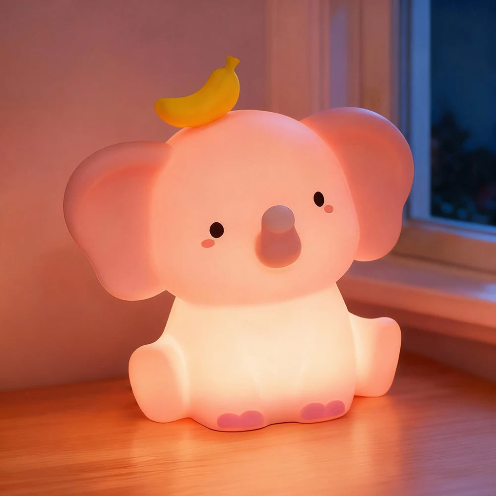 Cute elephant-shaped kawaii night light with a banana on its head, glowing softly.