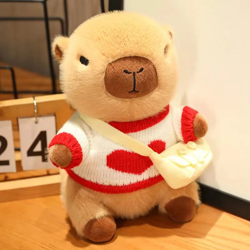 Kawaii plush bear toy wearing a red sweater with white hearts on a wooden surface.