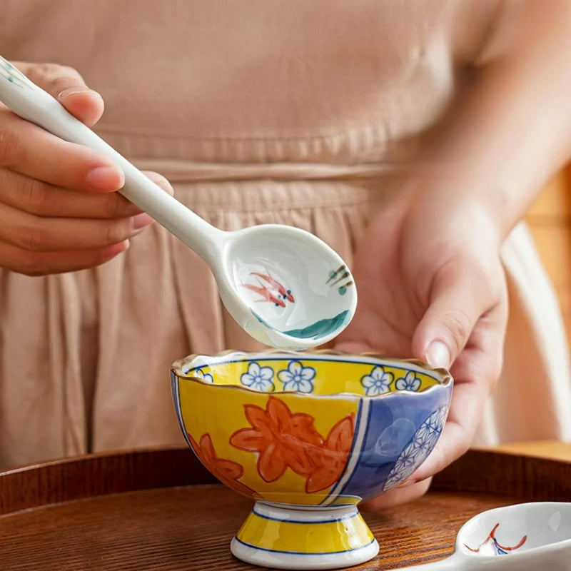 Someone eating from a ramen bowl with a kawaii spoon