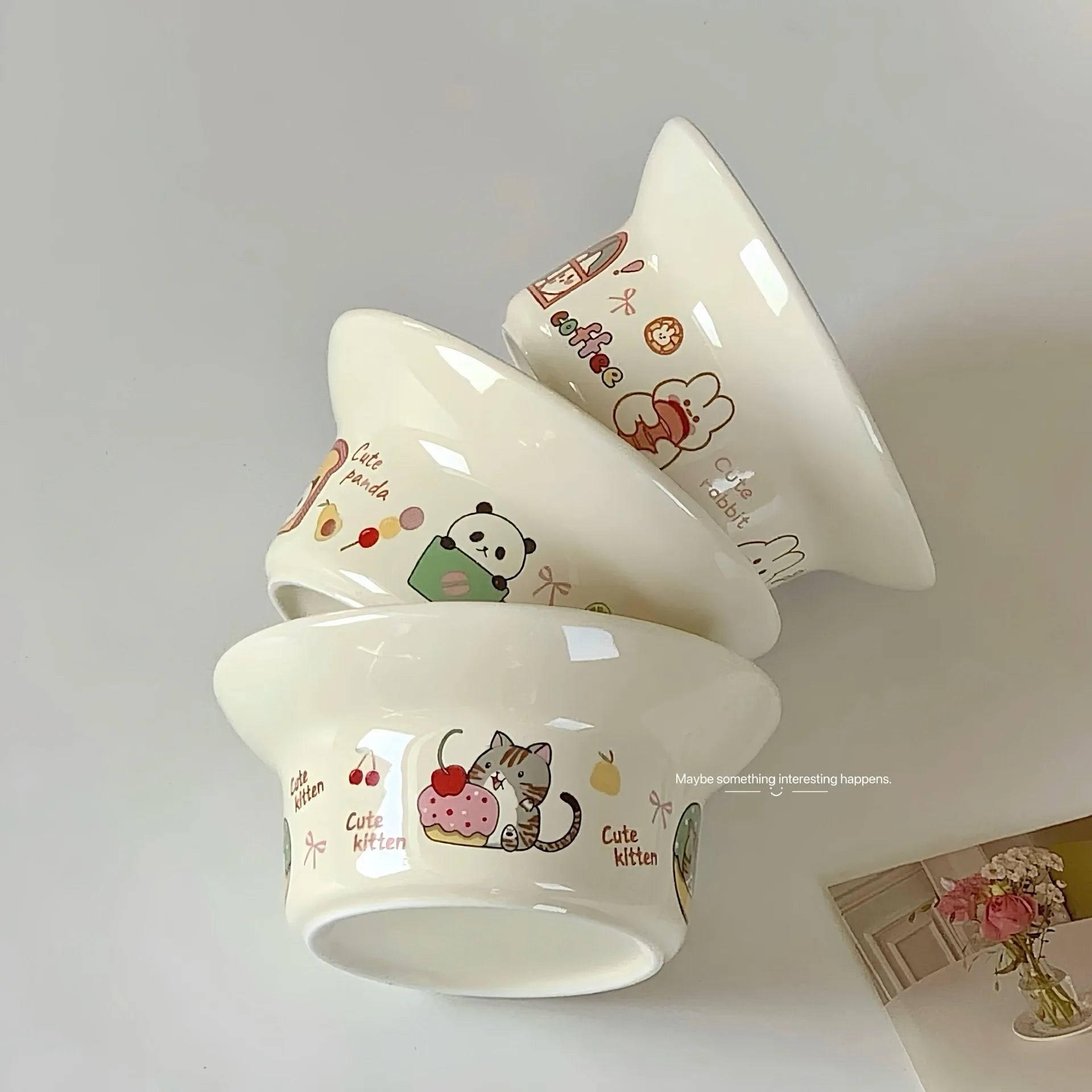 Set of three white ceramic kawaii ramen bowls with cartoon designs on a light gray background
