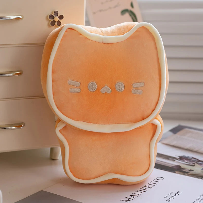 Orange cat-shaped kawaii cushion on a surface with a blurred background