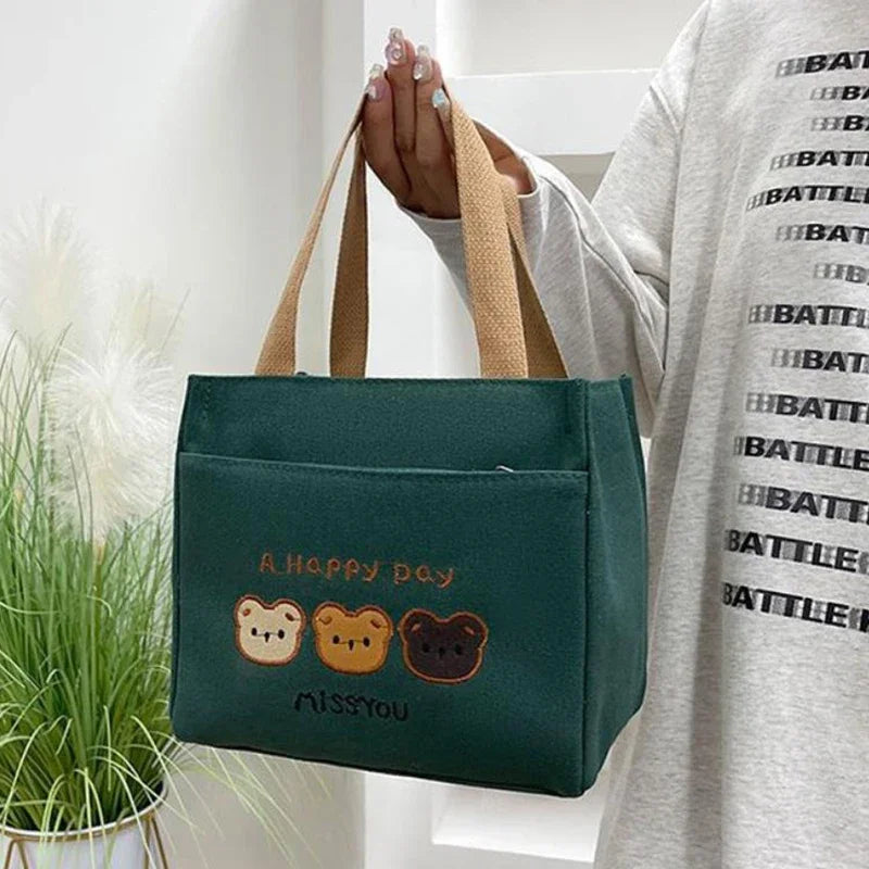 Green kawaii tote bag with bear illustrations held by a person wearing a 'BATTLE' shirt.