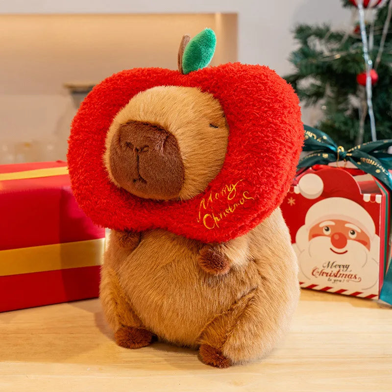 Kawaii plush toy resembling a dog wearing a red 'Merry Christmas' collar with Christmas presents and decorations in the background.