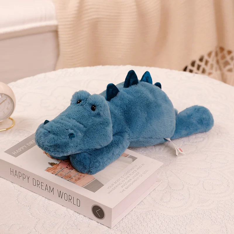 Blue kawaii plush dragon toy on a book with a soft background