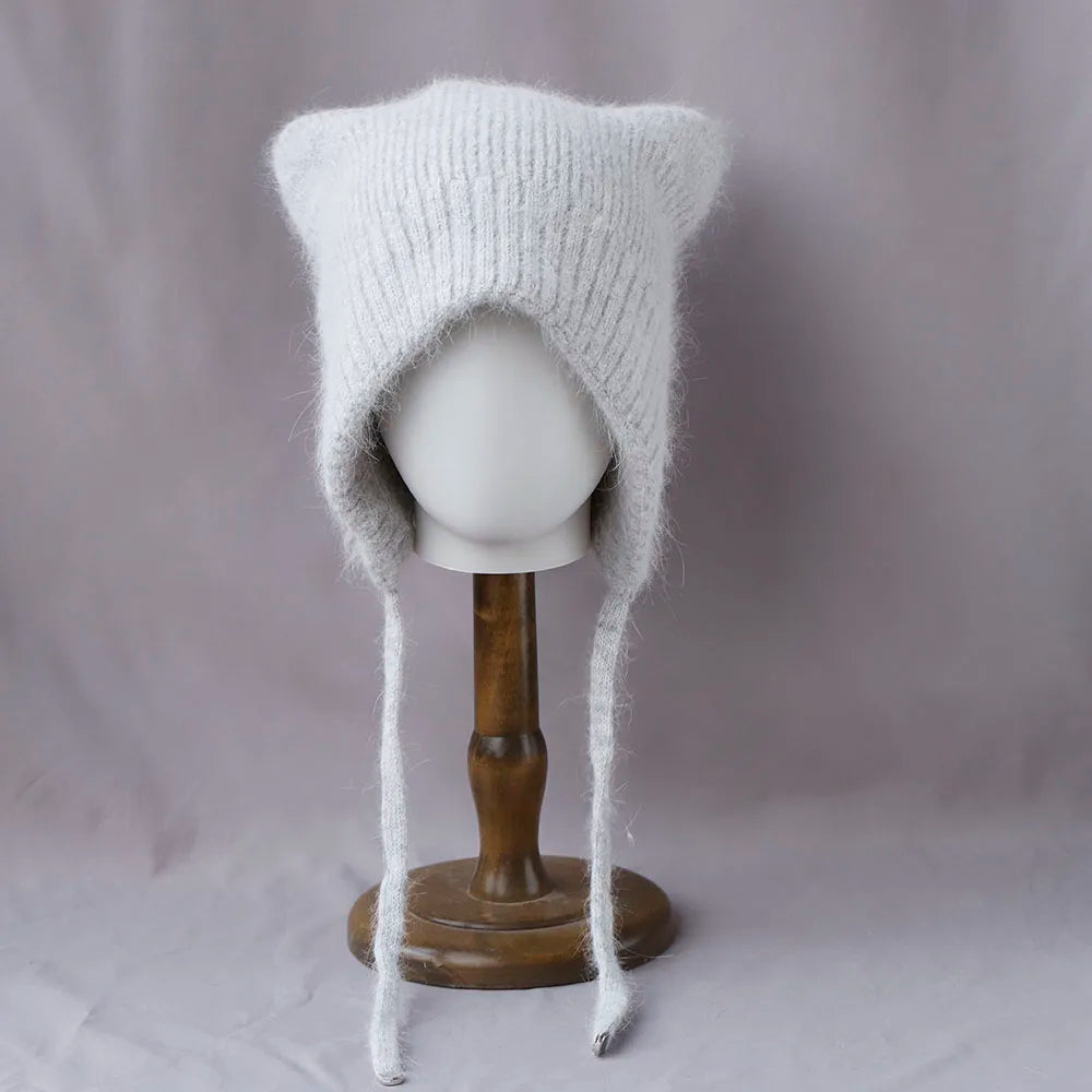 Knitted cat ear Kawaii hat on a mannequin head against a plain background