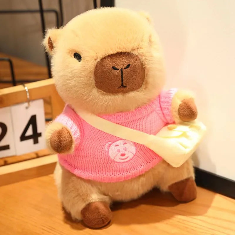 Kawaii plush bear toy wearing a pink sweater on a wooden surface