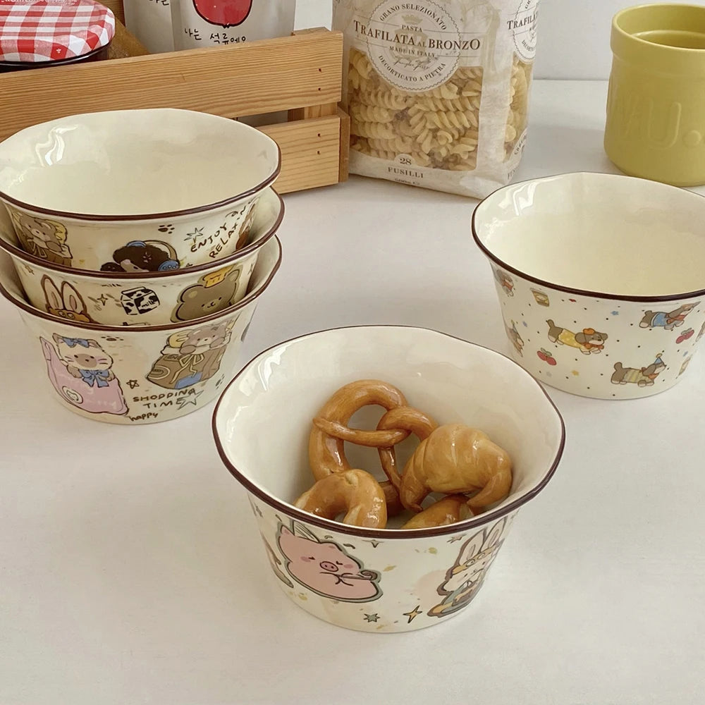 Set of cartoon-themed ceramic kawaii ramen bowls with cookies on a white surface