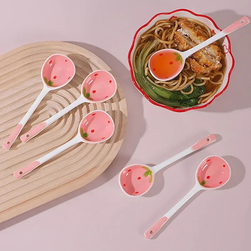 A group of strawberry designed kawaii spoons on a table