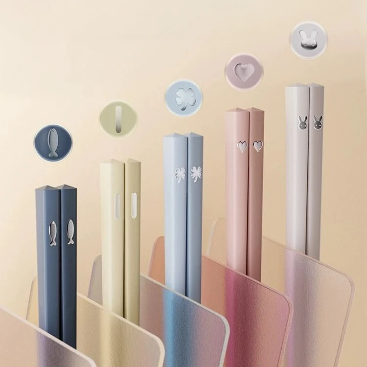 Set of colorful kawaii chopsticks with decorative elements on a beige background