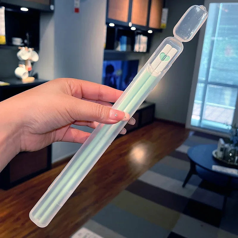 Hand holding a kawaii chopsticks in a blurred indoor background