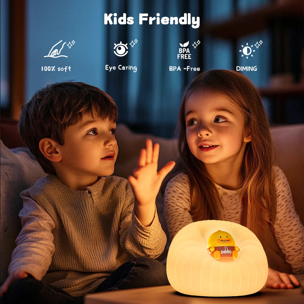 Two children sitting together with a kawaii night light on a table, surrounded by soft lighting.