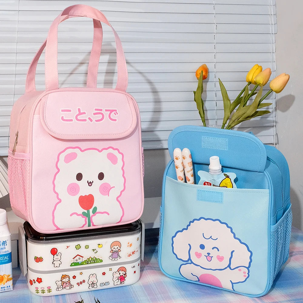 Pink kawaii lunch bag with cartoon character, blue pouch with dog illustration, and stacked containers on a table.