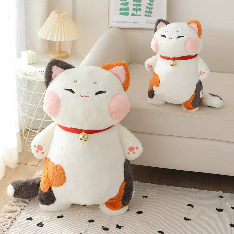 Two plush cat toys with orange accents on a carpeted floor.