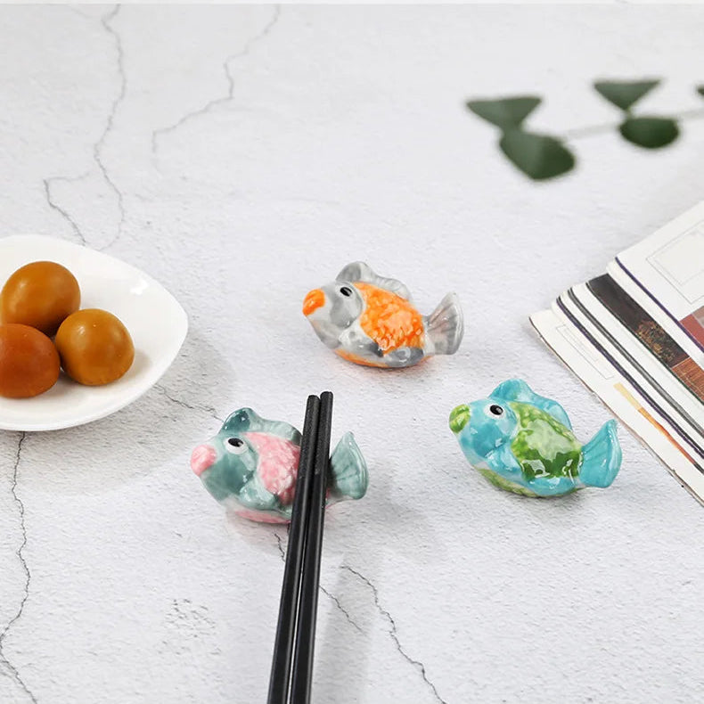 Three multicolored fish shaped kawaii chopstick holders