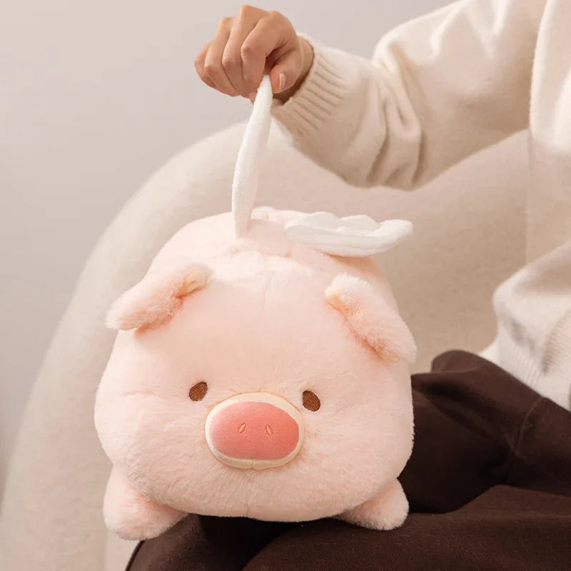 Person holding a kawaii plush pig toy with a neutral background