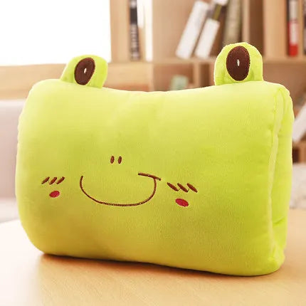 Green frog-shaped kawaii pillow on a wooden surface with a blurred background