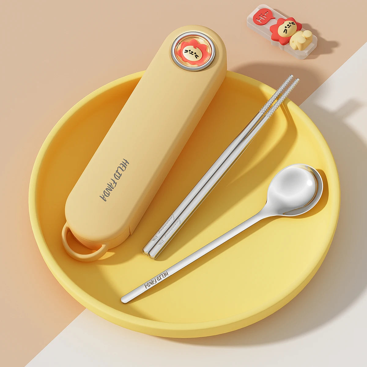 Yellow kawaii utensils with silver spoon, and straw on a yellow plate against a beige background