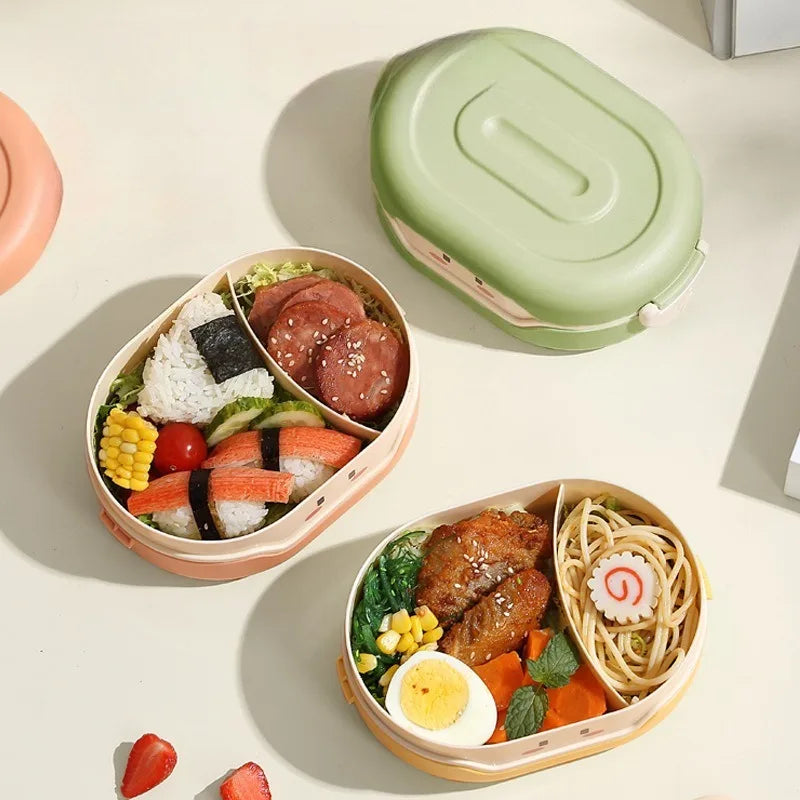 Two kawaii bento boxes with food on a light surface