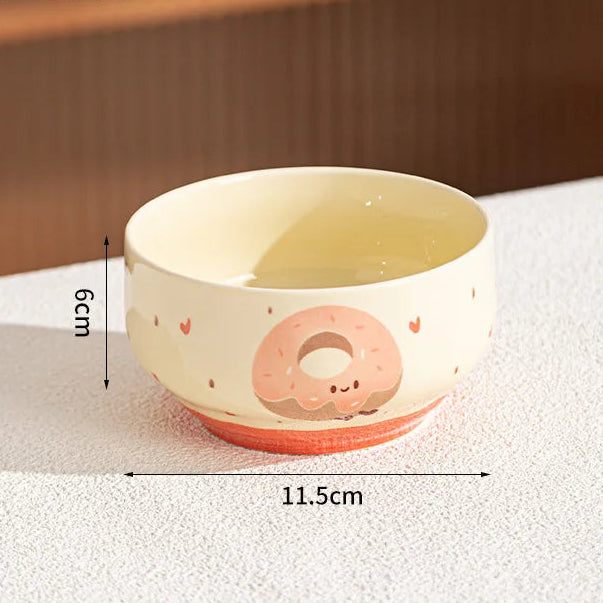 Small ceramic kawaii bowl with a donut design on a white surface, showing measurements.