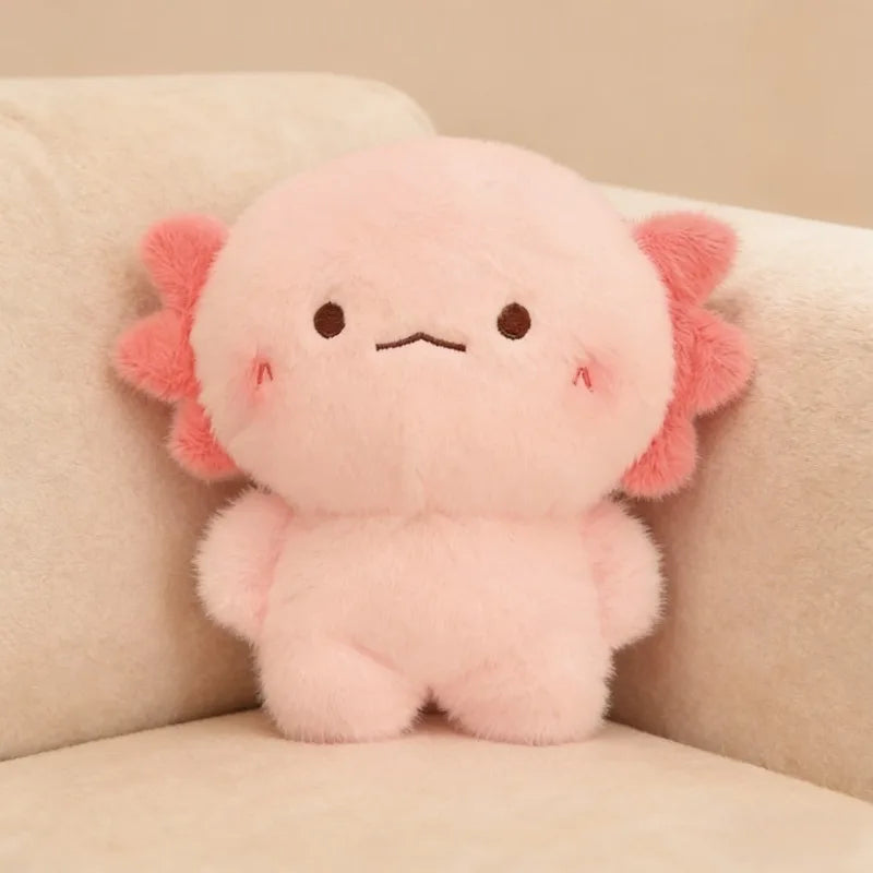 Pink kawaii plush toy with flower-like ears on a beige couch