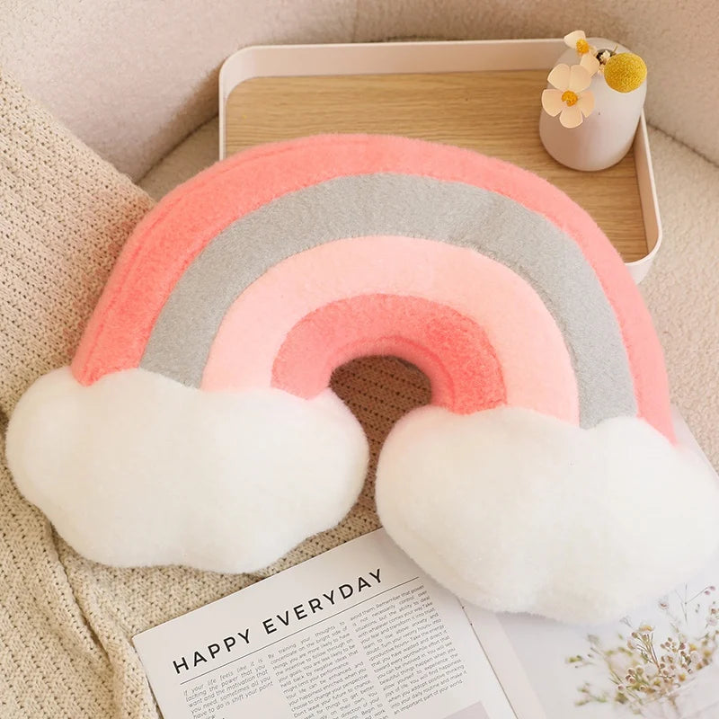 Decorative rainbow kawaii pillow with clouds on a magazine