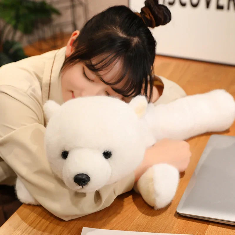 Person hugging a large white kawaii plush bear on a wooden table.