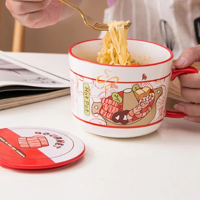 Person eating noodles from a cartoon-themed kawaii ramen bowl on a table with a magazine and coaster.