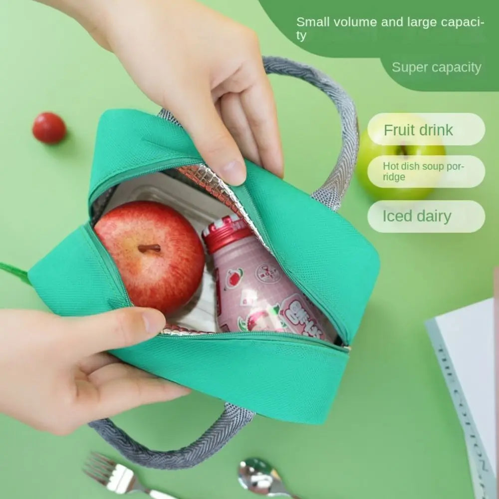 Green snack kawaii bag with an apple and juice bottle, held by hands on a green background.