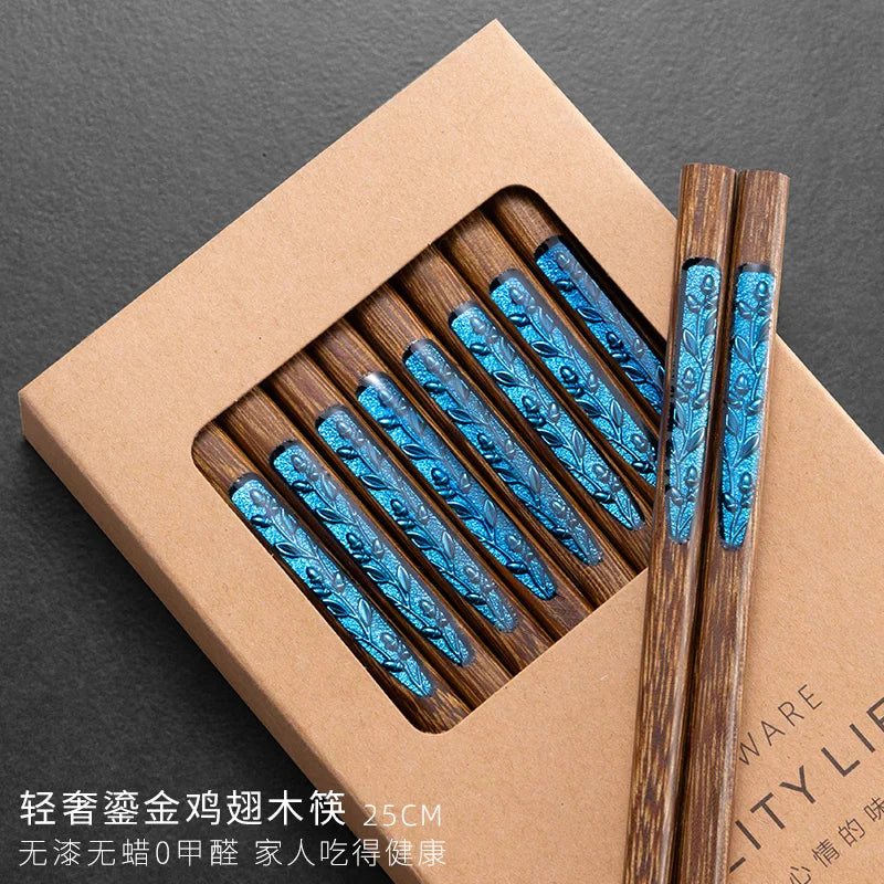Wooden kawaii chopsticks with blue patterns in a brown box on a dark background