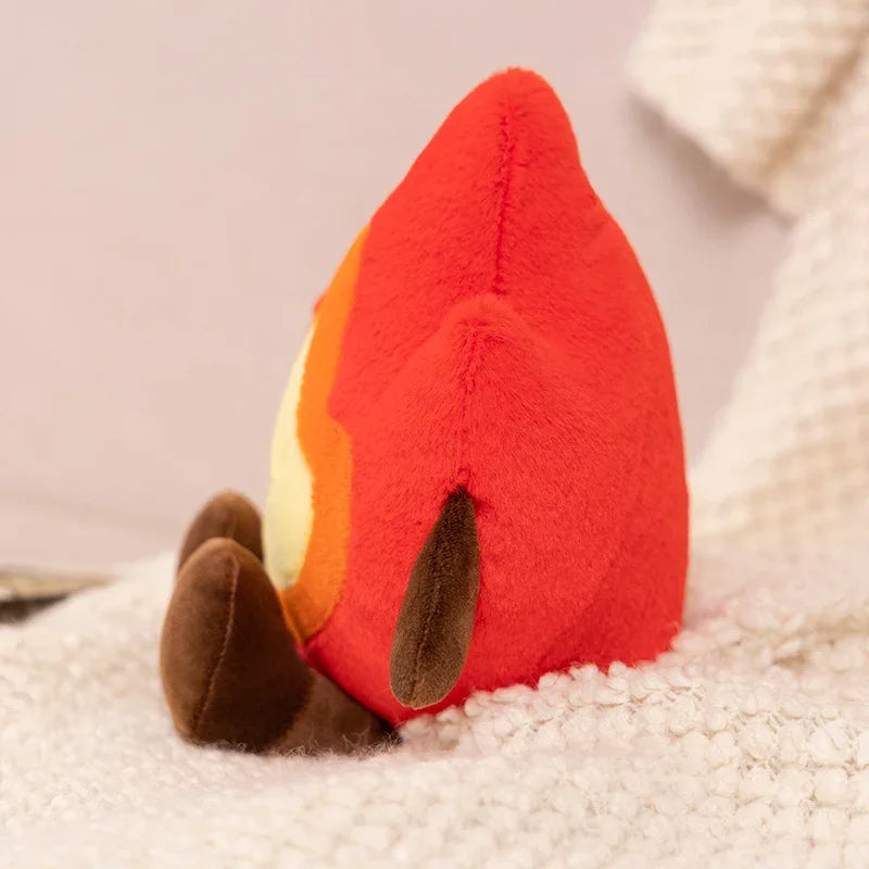 Red kawaii plush toy with a heart design on a soft surface
