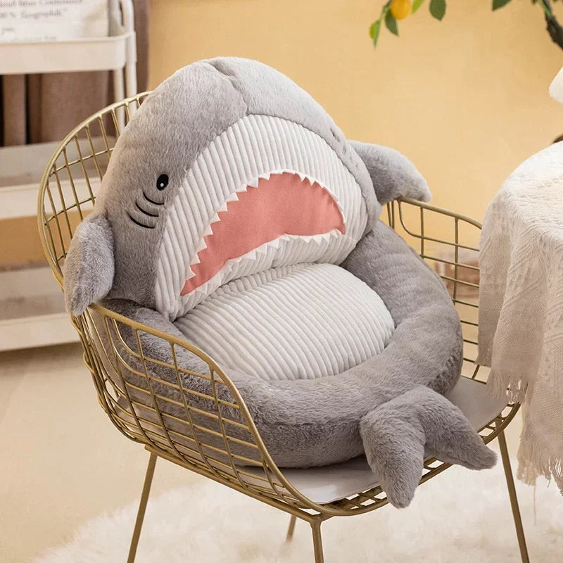Shark-shaped kawaii cushion on a wire chair with a blurred background