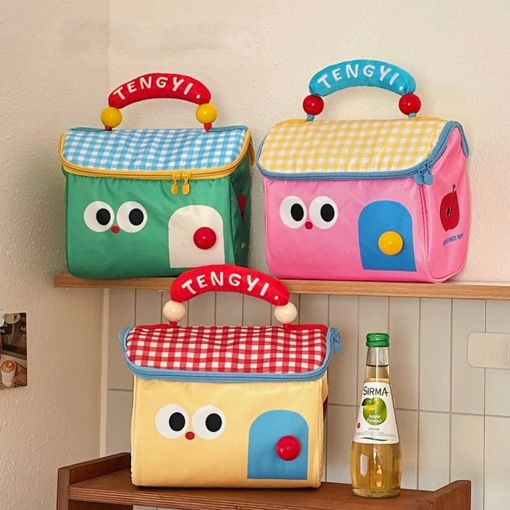 Three colorful kawaii lunch bags with cartoon faces on a shelf, featuring the brand 'TENGYI'.