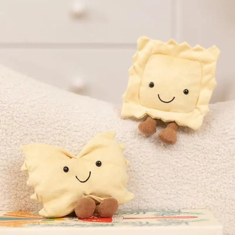 Two kawaii plush toys shaped like cartoon-like crackers on a textured surface.