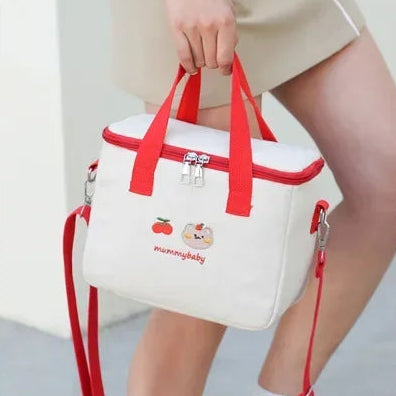 White kawaii bag with red accents held by a person, with another person wearing the bag on their shoulder.