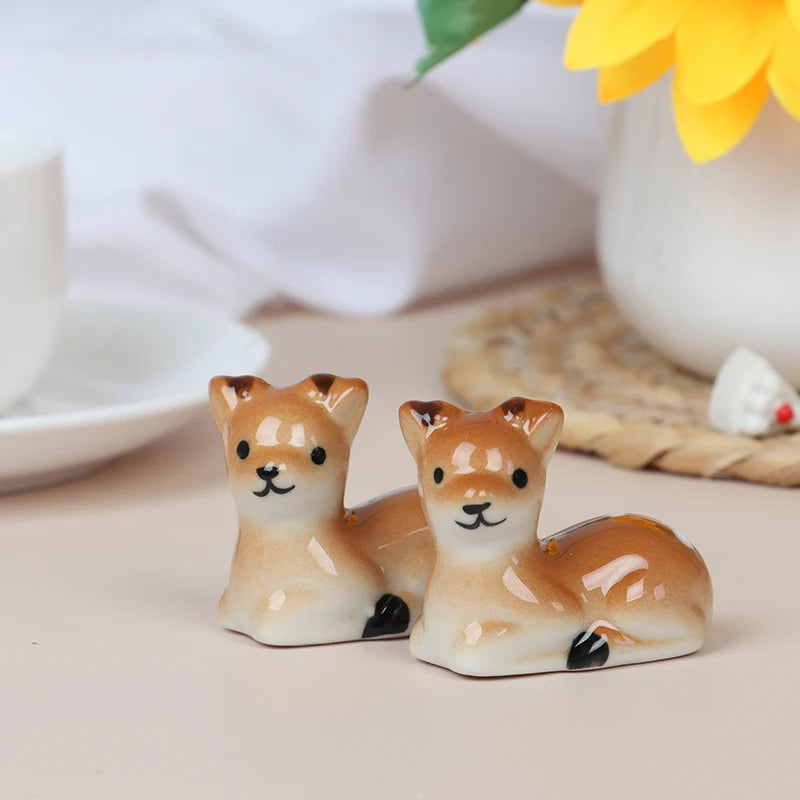 Two ceramic deer kawaii chopstick holders on a light surface with a blurred background