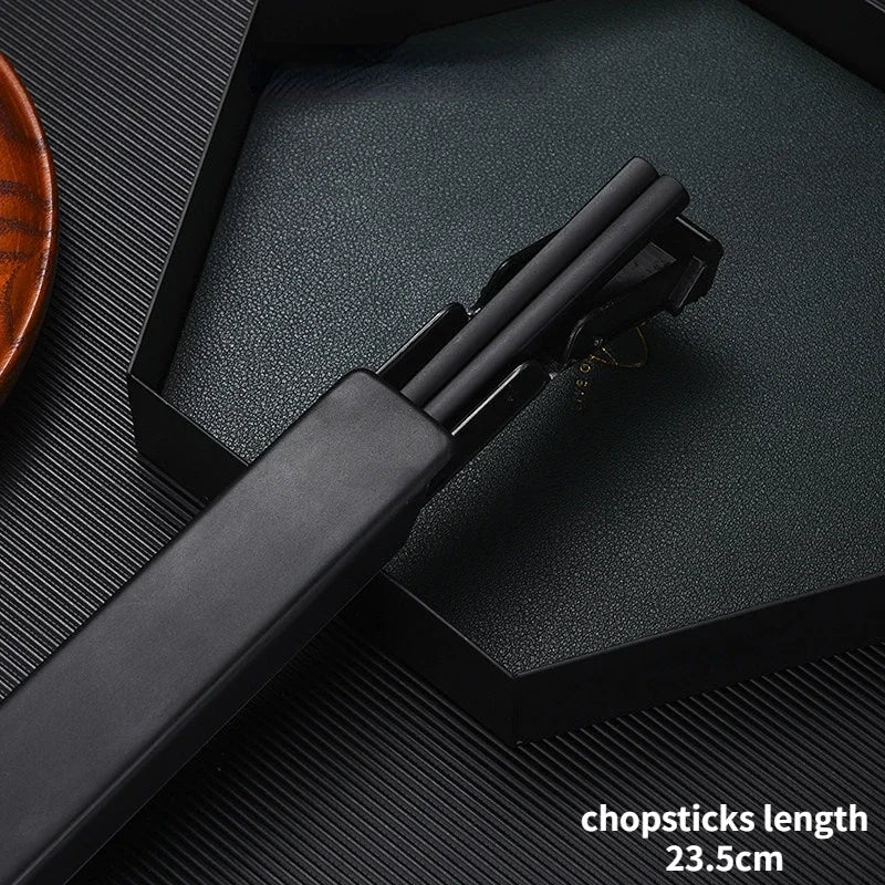 Black kawaii chopsticks set in a holder on a dark textured surface with text indicating length.