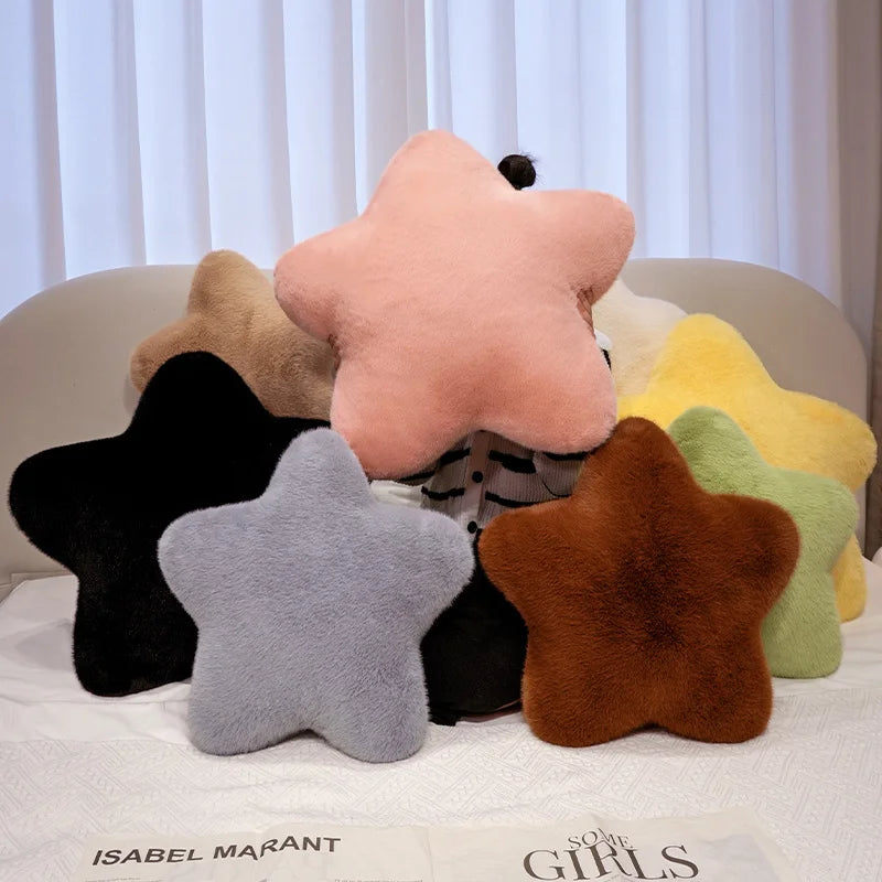 Star-shaped cushions in various colors on a surface with a blurred background