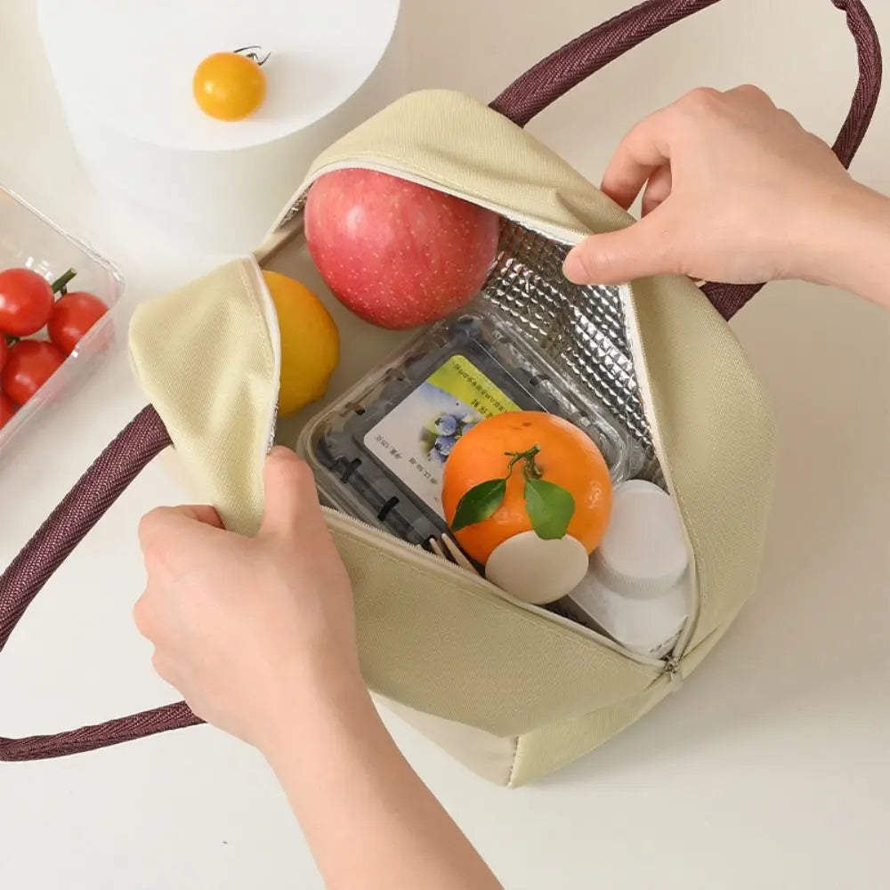 Hands opening a beige kawaii cooler bag filled with fruits and items on a white background