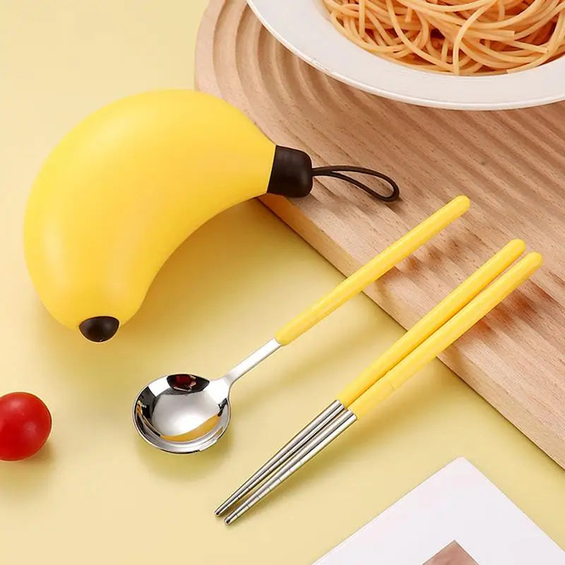 A yellow banana shaped kawaii utensils on a table