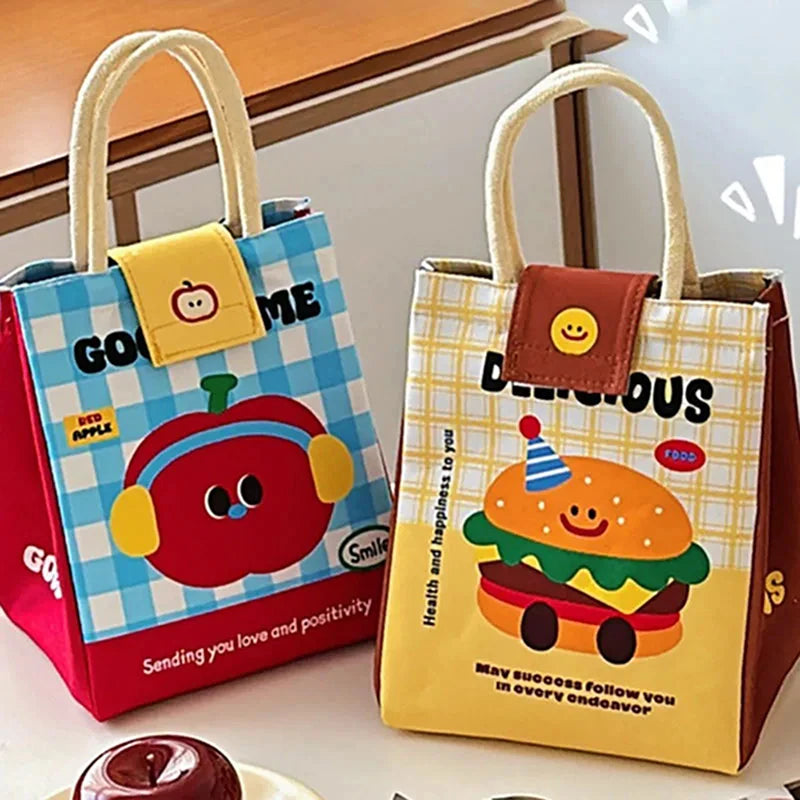 Two colorful children's kawaii lunch bags with cartoon designs on a wooden surface.