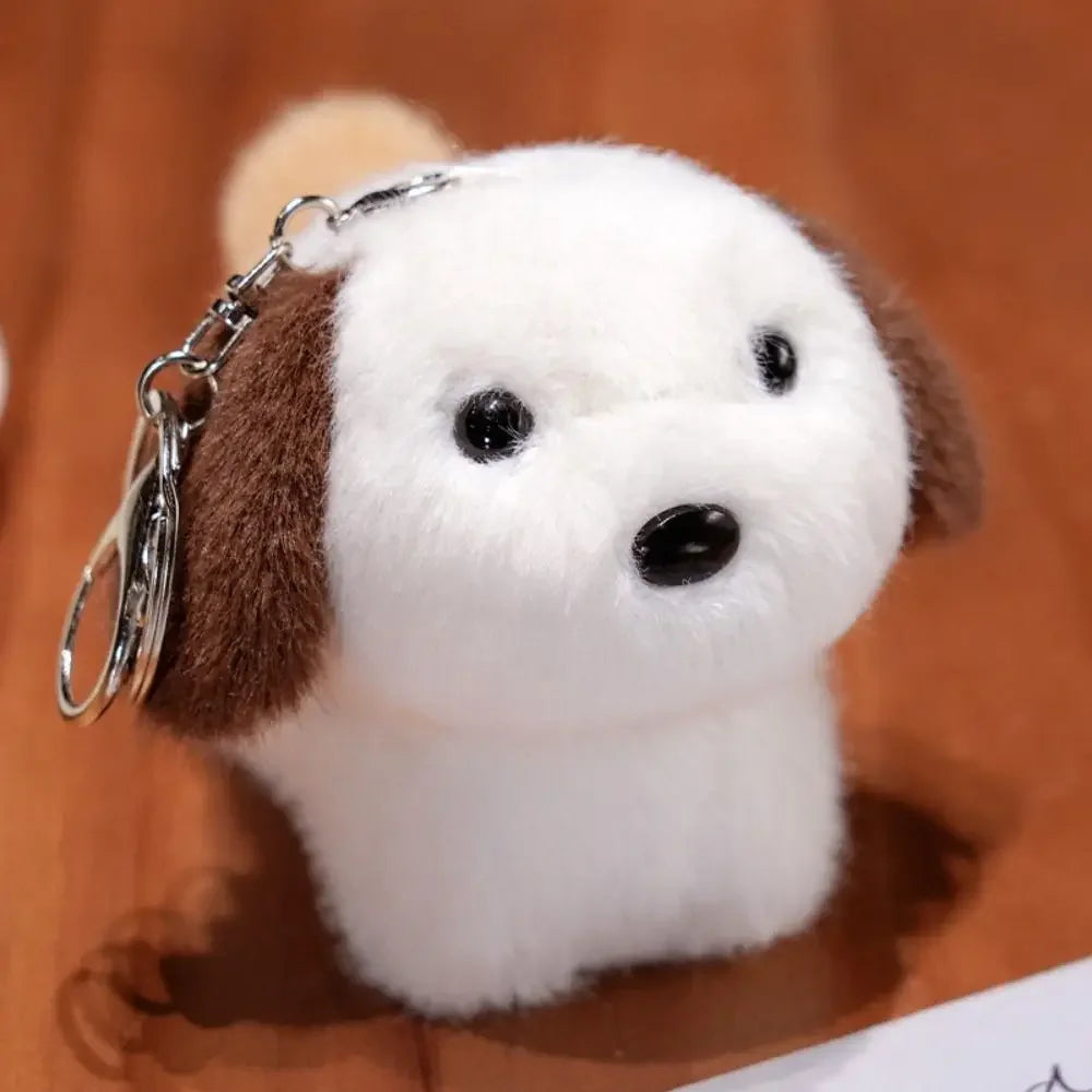 Kawaii plush dog keychain with a brown and white color scheme on a wooden surface.
