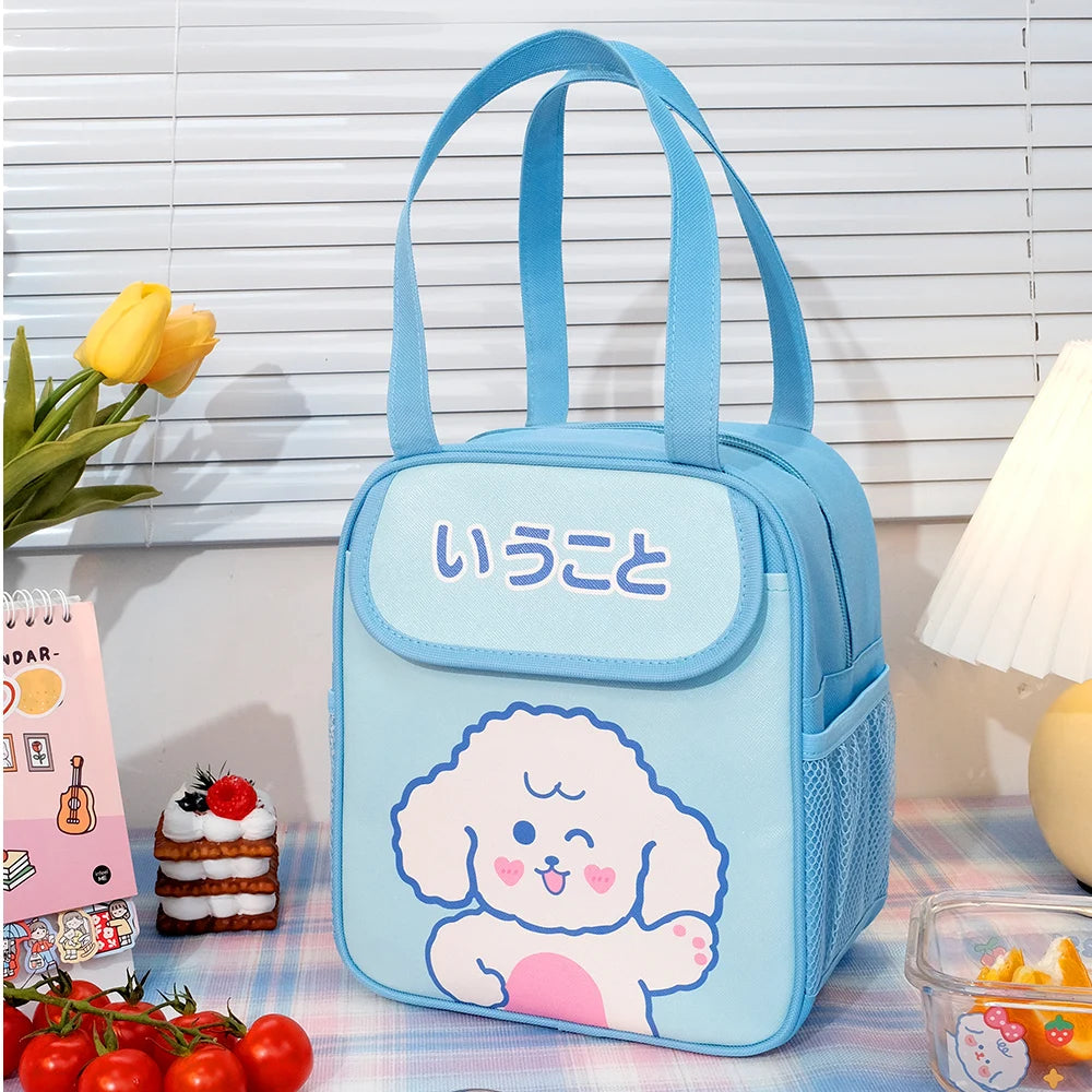 Blue kawaii lunch bag with a cartoon dog design on a table with snacks and flowers.