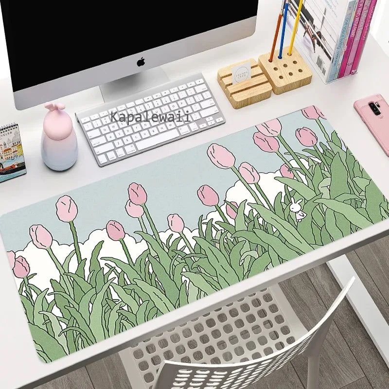 Desk setup with a Kawaii floral mouse pad, keyboard, and office items.